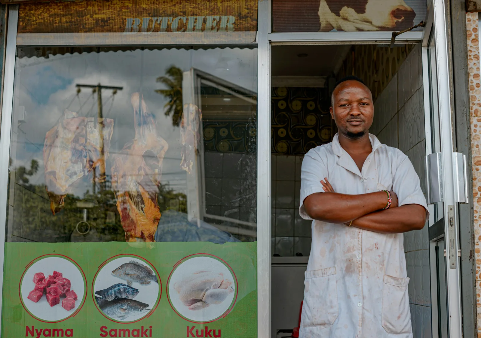 A shop owner standing in the doorway of his store